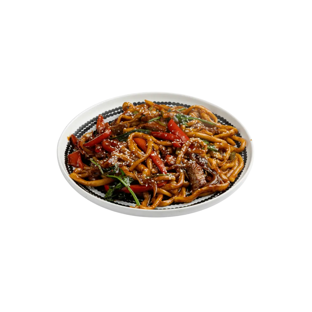 Fried Legmen noodles with greens on a white plate.